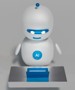 Un petit robot sympathique devant un ordinateur portable