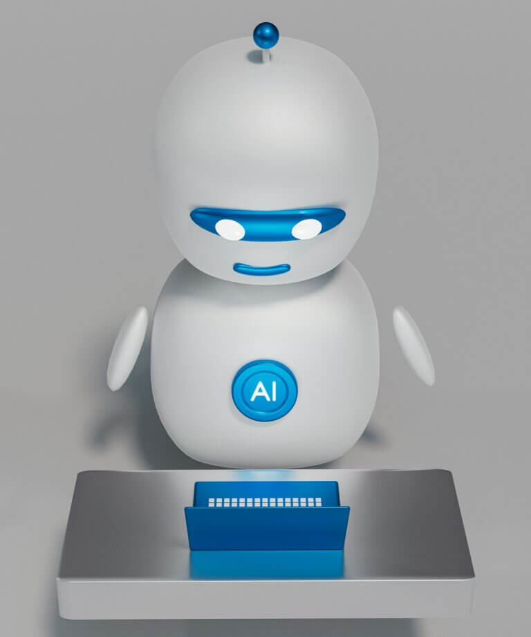Un petit robot sympathique devant un ordinateur portable